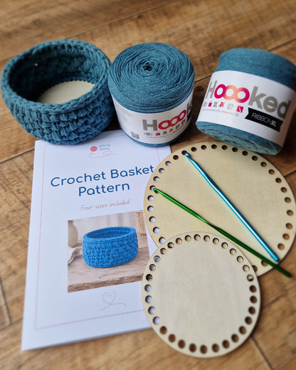 Crochet trinket basket making kit with blue yarn, wooden bases, crochet hooks and printed pattern